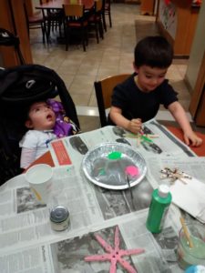 Aliyah sits at the table with her twin brother Ezra
