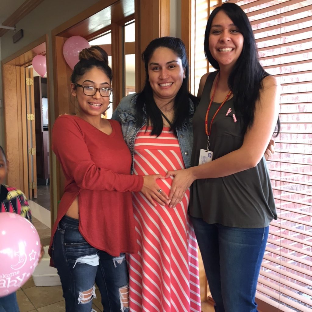 Maria standing with other moms at her baby shower