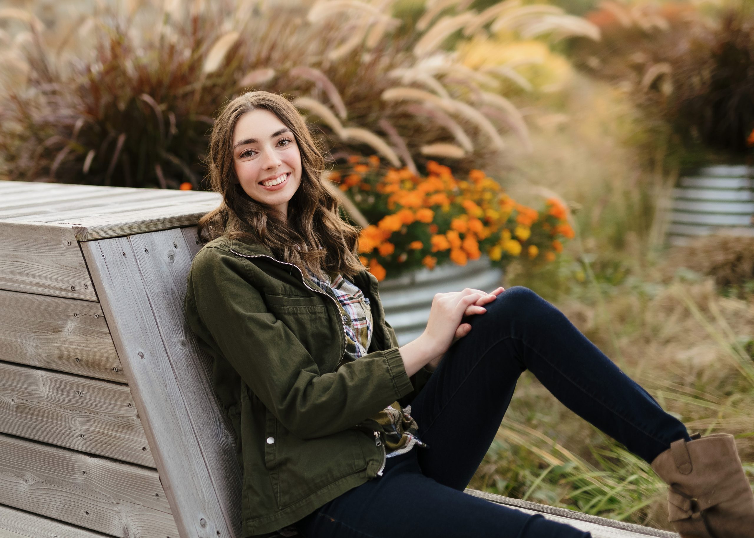 Taylor sits on a bench for her senior photos, taken shortly before she needed to start using a wheelchair fulltime