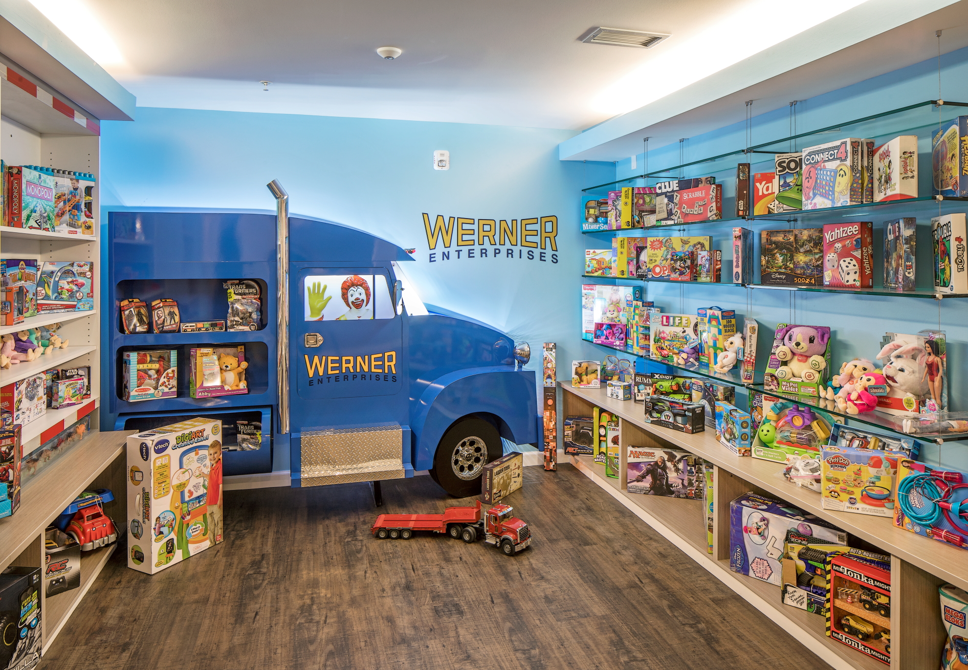 The glass-encased toy room near the front entry of the Ronald McDonald House is fully stocked with toys and features a picture of Ronald McDonald driving a Werner truck.