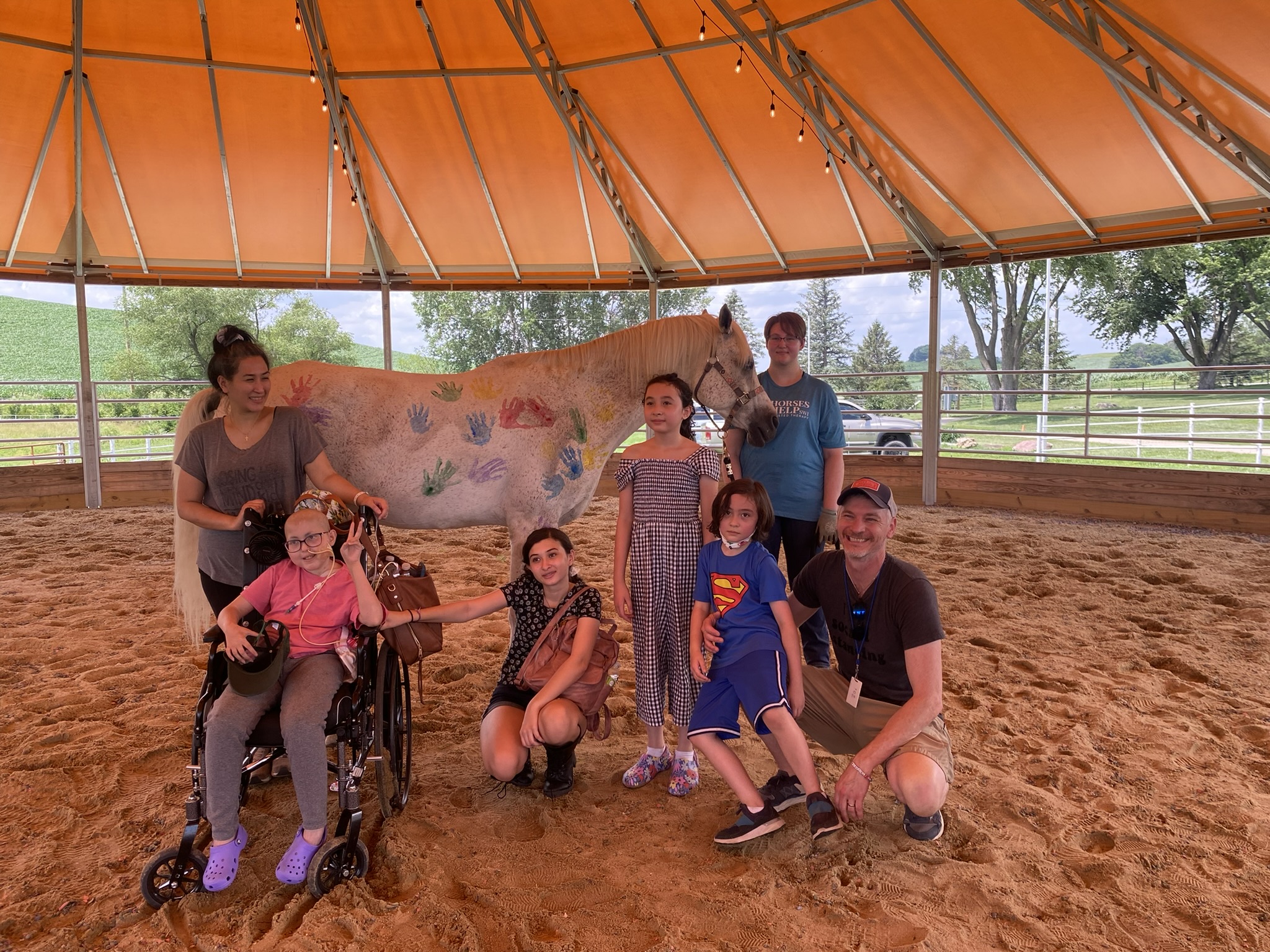 The Lucquete family poses for a photo in front of a horse