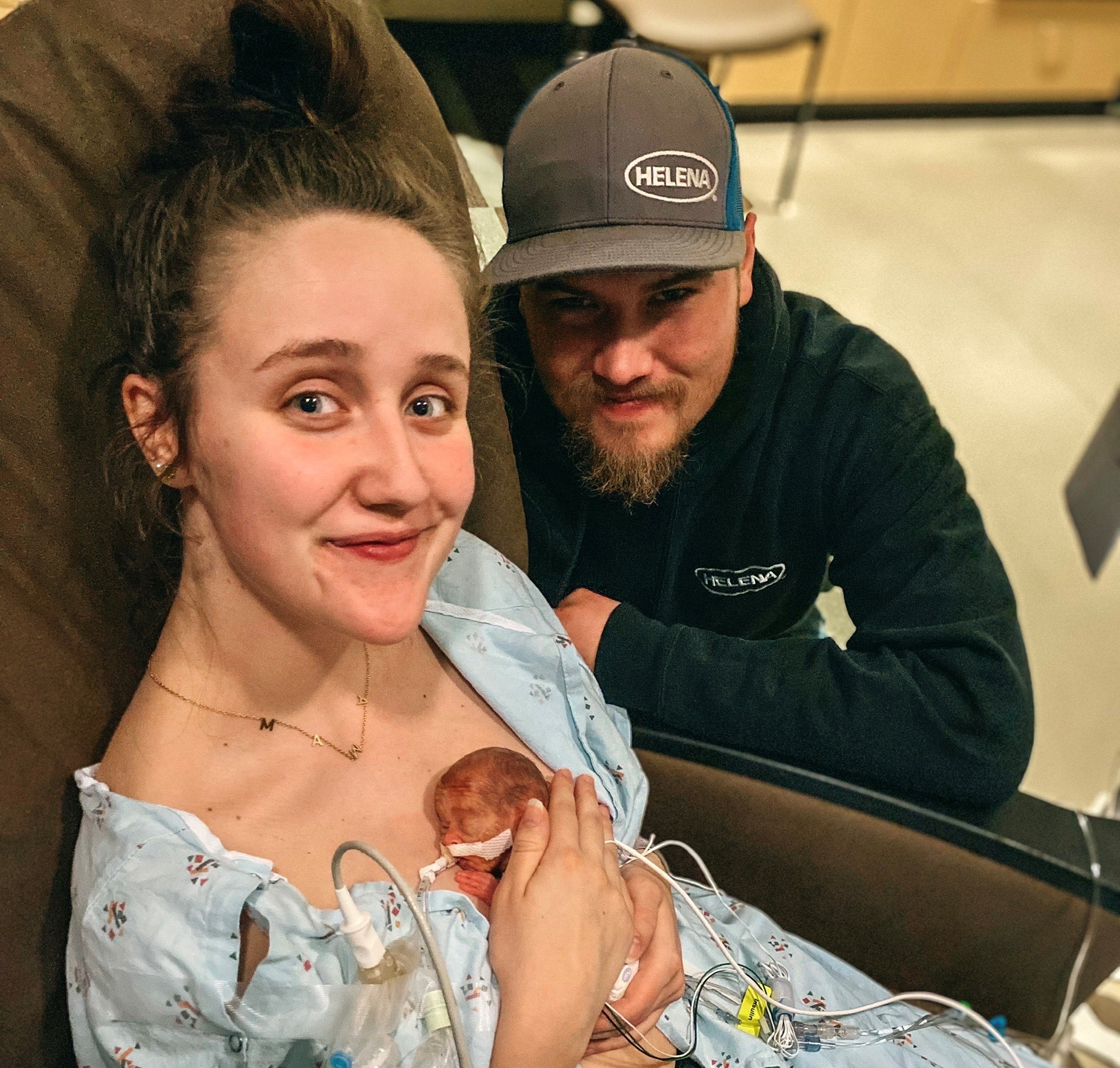 Taylor holds preemie Thayne with Couy next to her