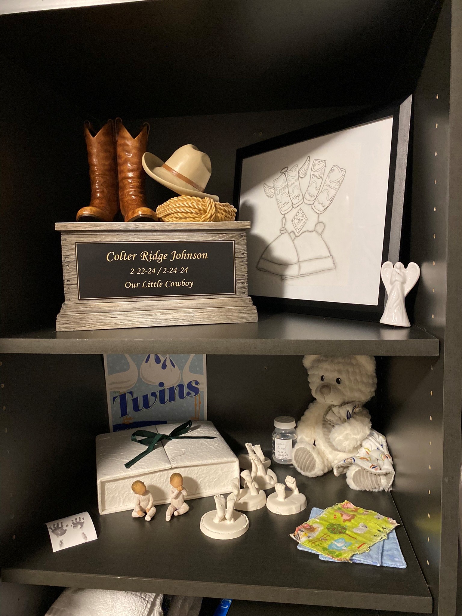 Colter's urn sits on a shelf next to a drawing and molds of his hands and feet