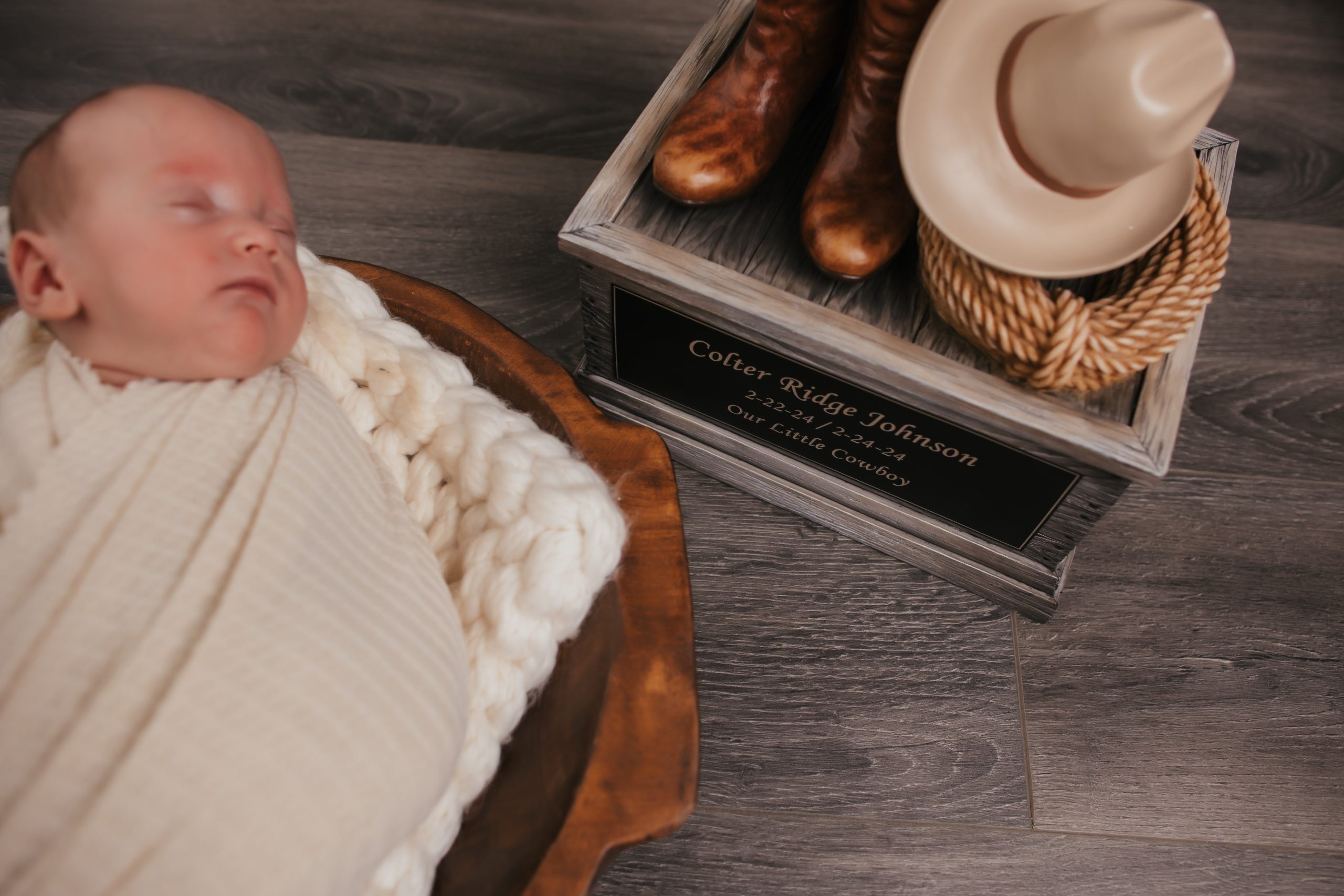 Baby Thayne lays in a basket next to Colter's urn